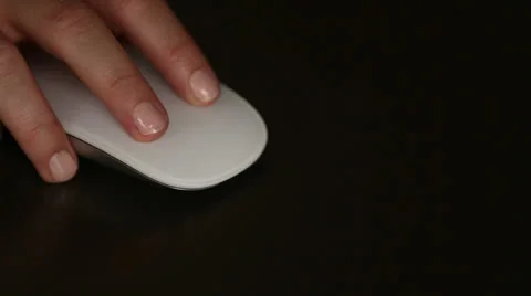 Person using wireless mouse on dark desk Stock Footage 26310038