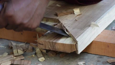 A person using a wood chisel to carve or shape a piece of wood Stock Footage 316237894