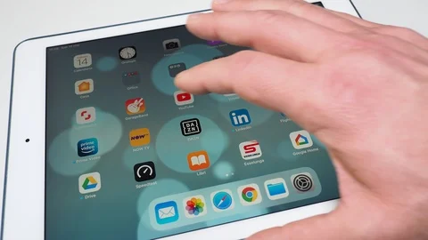Person is using youtube app on tablet computer device, scrolling videos Stock Footage