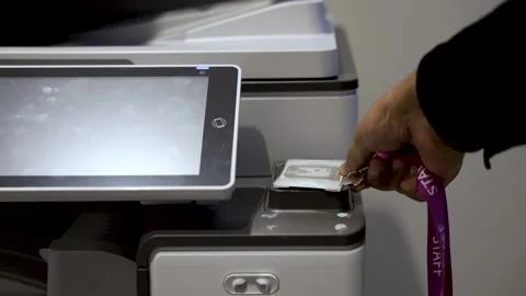 A person utilizes an identification badge to trigger the office printer, 스톡 동영상 266120400