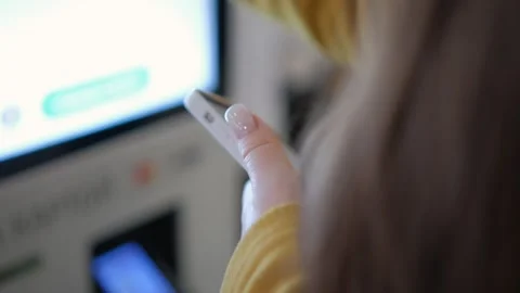 A person is utilizing a smartphone for a digital transaction at a selfservice Stock Footage 276547676