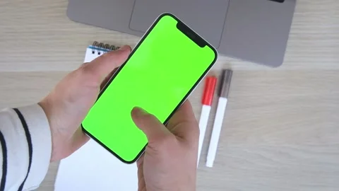 Person views scrolls the screen of a smartphone device. Zoom in on the phone Stock Footage 231131280