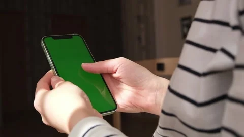 Person views scrolls the screen of a smartphone device. Zoom in on the phone Stock Footage 235929276