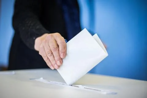 Person voting, casting a ballot Stock Photos