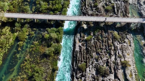 Person walking across bridge over rushing river canyon in bosnia Видео 341301949