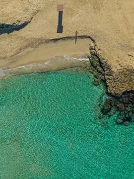 Person walking alone on Cala Comte beach, Ibiza. Stock Photos