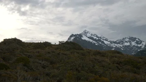 Person walking alone on epic mountain peaks Stock Footage 140611934
