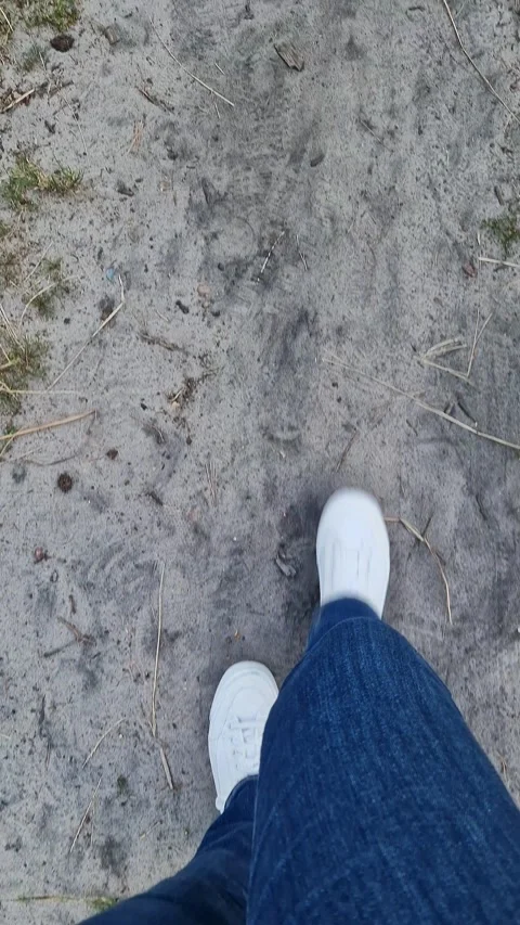 A person walking along a path among dry leaves and green grass Stock-Footage 344300768