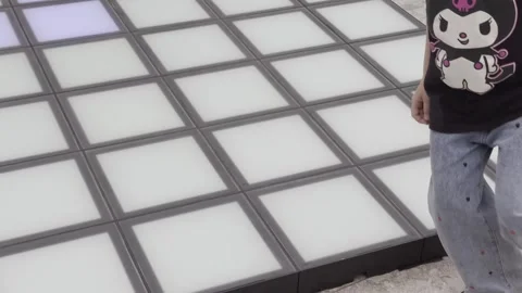 A person is walking on a dance floor with a lighted floor Stock-Footage 279823316