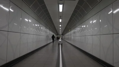 A person is walking down a long, empty hallway Stock Footage 297859538