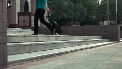 Person Walking Down Steps in Urban Setting Stock Footage 314665401