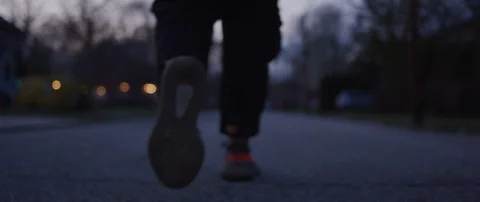 Person Walking Down Street During Dusk Stock Footage 129477347