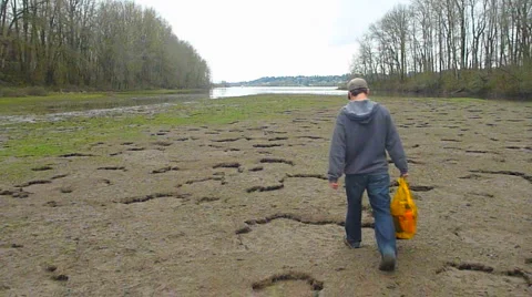 Person Walking on Dry Riverbed Stock Footage 2591856