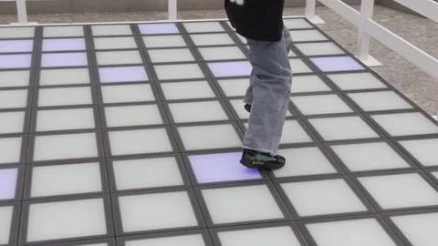 A person is walking on a floor with a pattern of squares Stock Footage 279823443