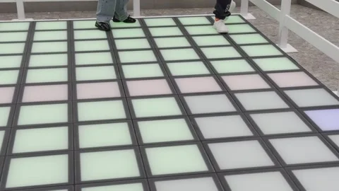 A person is walking on a floor with a pattern of squares Video stock 279823582