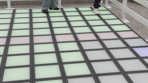A person is walking on a floor with a pattern of squares Video stock 279823591