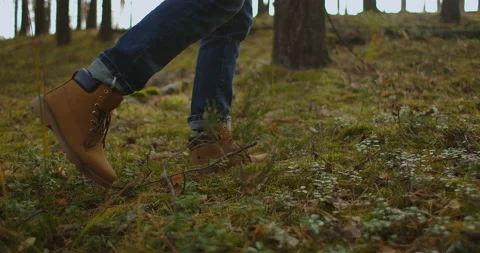 Person is walking in a forest. Close up focus on boot or hiking shoes. Close up Stock Footage 140649203