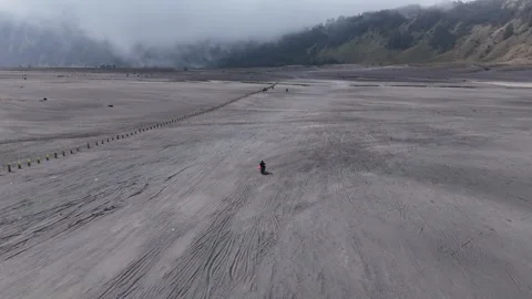 Person Walking on Mount Bromo Volcanic Sand Plain Indonesia Video stock 344892918