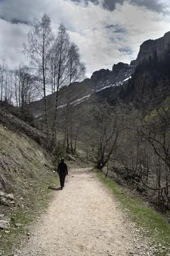 Person walking mountain trail exploring natural wilderness Stock Photos