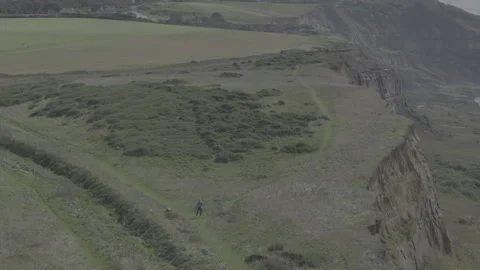 A person is walking on a path in a field Video stock 298284377