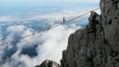 Person walking rope bridge, aerial view.... | Stock Video | Pond5