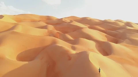 Person walking up a sand dune Stock Footage 98432111