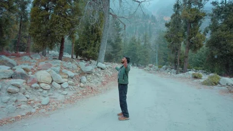 Person Walking in Snowfall Through Mountain in Chitkul, India on 5th June 2025 Stock Footage 333578585