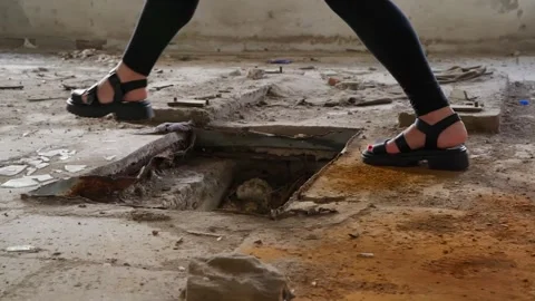 Person walking through abandoned deteriorating industrial floor with hazardous Video stock 342087524
