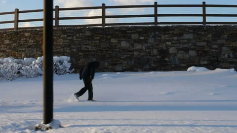 Person walking through deep snow in an urban environment Stock Footage 171908548