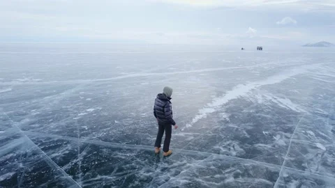 A person walks on ice, third-person view, Baikal lake, ice cracks Stock Footage 222046798