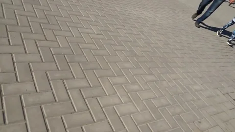 A person walks on a square that is covered with tiles. Stock Footage 100601034