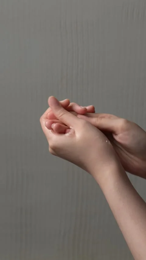 A person washes their hands, interlacing their fingers, ensuring thorough h.. Stock Footage 304213280