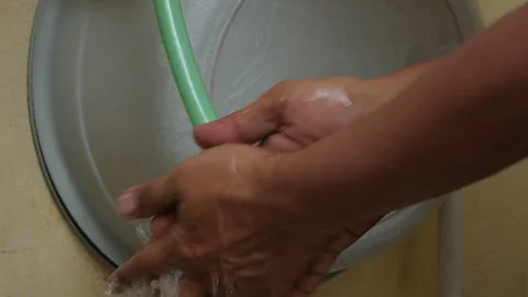 Person Washing Hands Under Running Water in a Basin Stock Footage 346133100