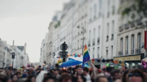 Person waving rainbow flag during pride parade Stock Footage 346990223