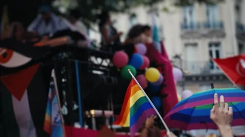 Person waving rainbow flag during pride parade celebration Stock Footage 346990256