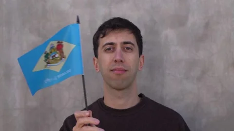 Person waving the state flag of Delaware in slow motion. Close up. Stock Footage 342927574