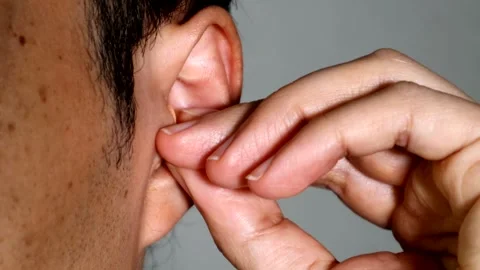 A person wearing earplugs Stock Footage 334646325