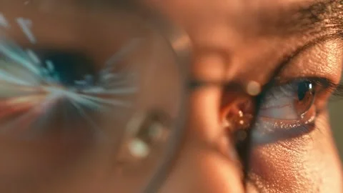 A person wearing glasses has dynamic digital light streaks. Stock Footage 317988236