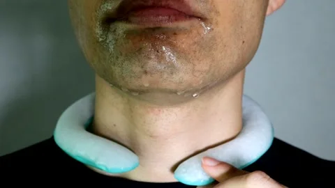 A person wearing an ice pack around their neck Stock Footage 334637320