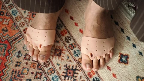 Person Wearing Silicone Toe Separators on a Patterned Rug Video stock 336227775