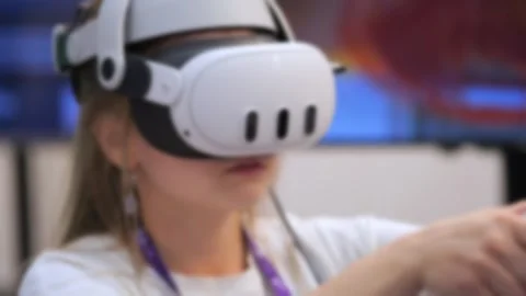 Person wears VR headset, holds controller, immersed in virtual experience Video stock 346148548