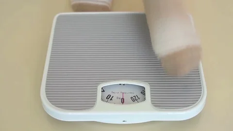 Person on the weight scale Stock Footage 80650695