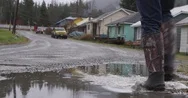 Person In Wellington Boot Walking On A Road During Rainy Season Stock Footage