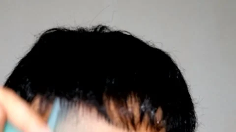 A person wetting and styling their hair Stock Footage 329339937