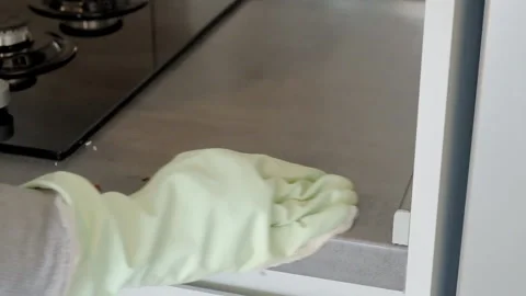 A person wipes the kitchen surface with a rag Stock Footage 228935961