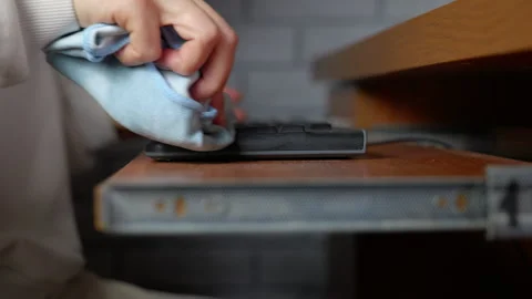 Person wiping dust off a computer keyboard Stock Footage 334561371