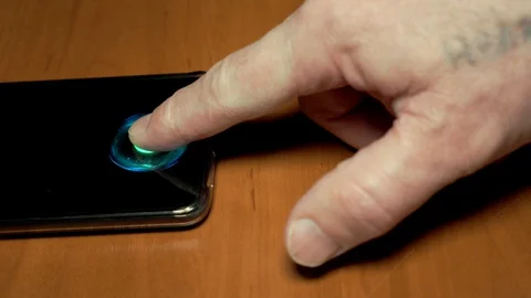 A person without fingerprints cannot unlock the phone with a scanner. Stock Footage 128681917
