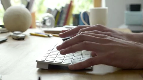 Person is working with computer and type on white keyboard. Camera is Stock Footage 245426601