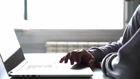 Person working with the computer from home at their desk. Hand using laptop t Stock Footage 133233449