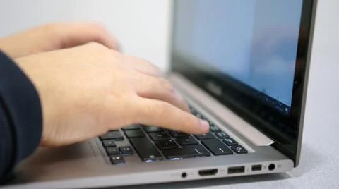 Person working on the computer, typing on the keyboard. Farthest angle Foto stock